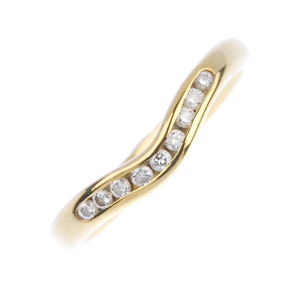 (161740) An 18ct gold diamond chevron ring. Designed as a curved channel of brilliant-cut diamonds