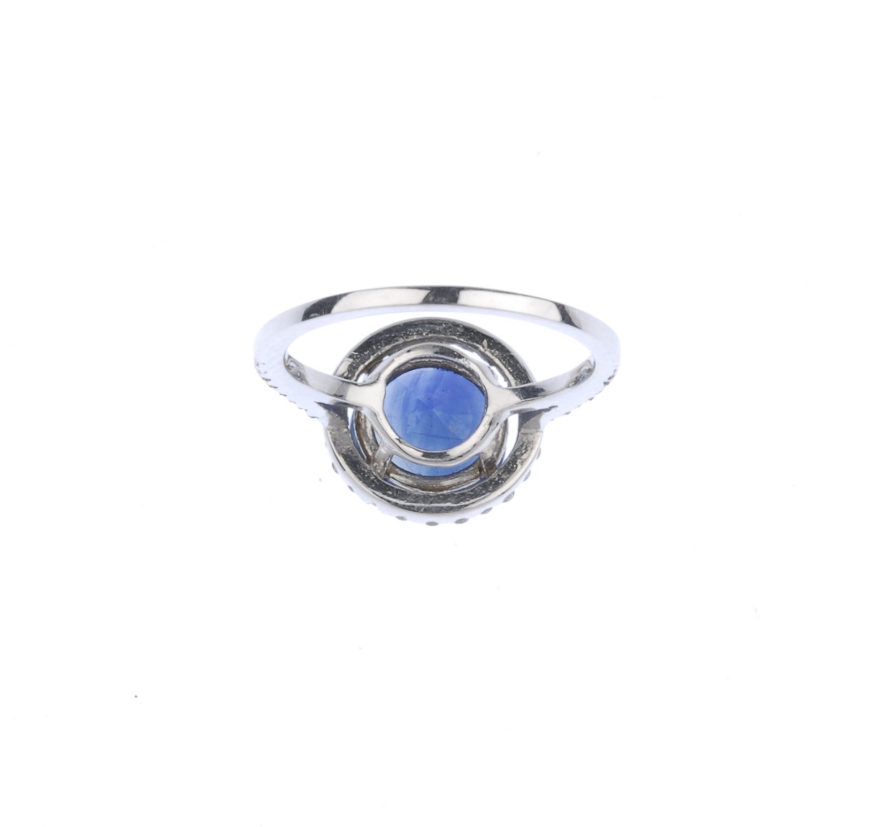 (539356-2-A) A sapphire and diamond cluster ring. The circular-shape sapphire, with brilliant-cut - Image 3 of 4