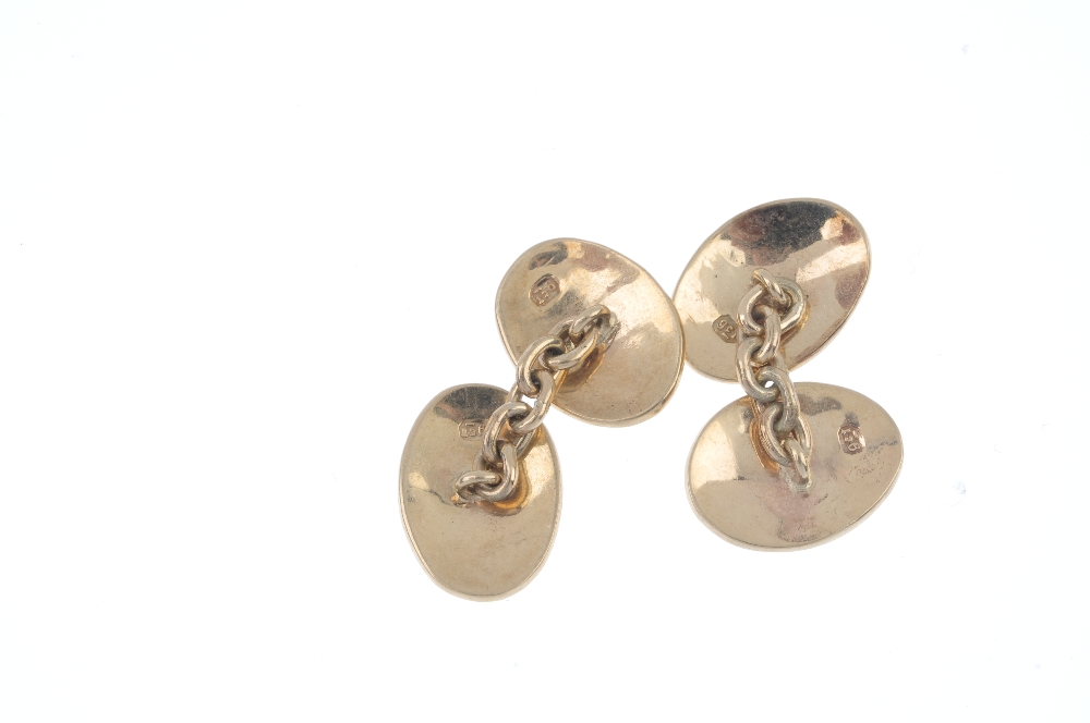 A pair of early 20th century 9ct gold cufflinks. Each designed as two oval-shape plain panels, - Image 2 of 2