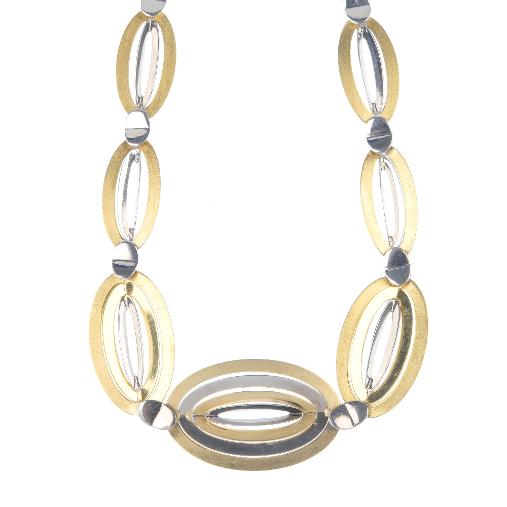 A set of jewellery. The necklace designed as a bi-colour series of graduated oval-shape vari-