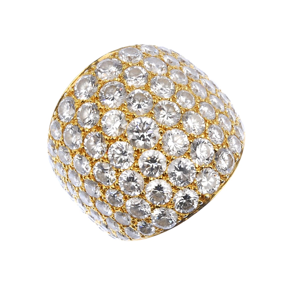 (539584-1-A) A diamond dress ring. The pave-set diamond bombe panel, to the tapered band. Signed