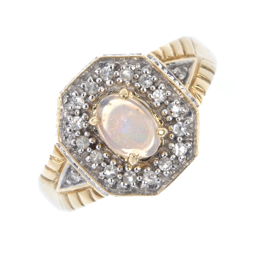 A 9ct gold opal and gem-set ring. The oval opal cabochon, within a colourless-gem surround and