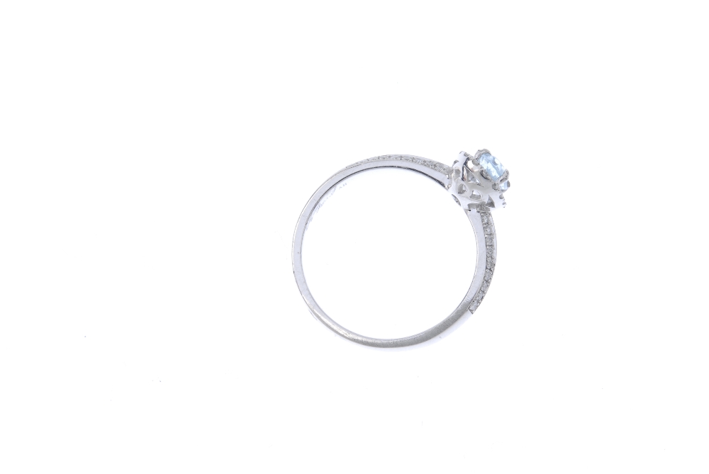 An aquamarine and diamond dress ring. The oval-shape aquamarine, within a brilliant-cut diamond - Image 4 of 4