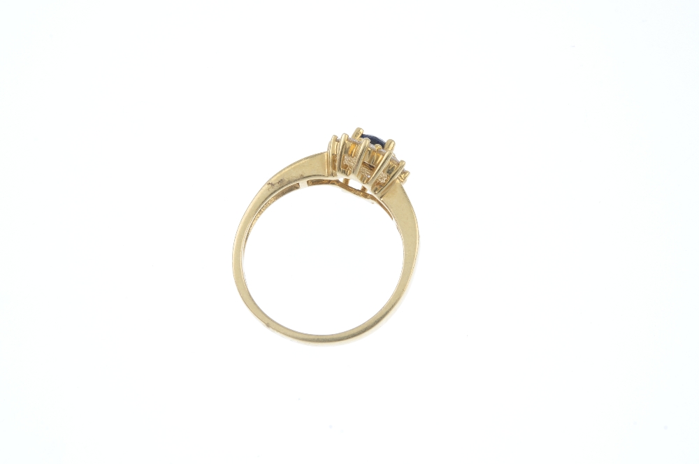 An 18ct gold sapphire and diamond cluster ring. The oval-shape sapphire, within a brilliant-cut - Image 4 of 4