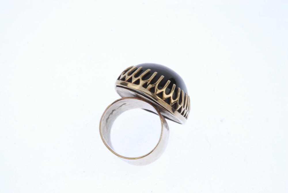 A 1970s 9ct gold tiger's eye dress ring. The cushion-shape tiger's eye cabochon, within an elongated - Image 4 of 4