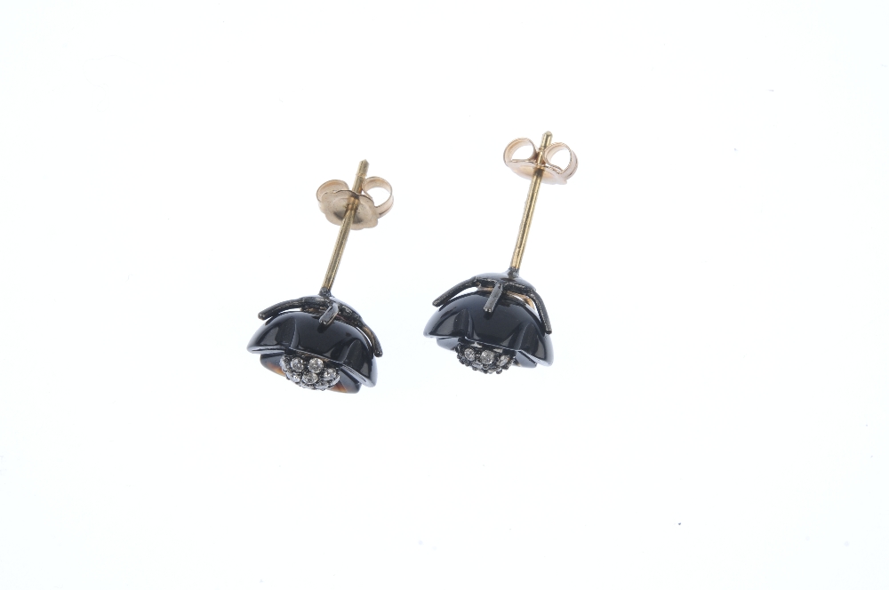 A pair of onyx and diamond floral ear studs. Each designed as a brilliant-cut diamond cluster, - Image 2 of 2