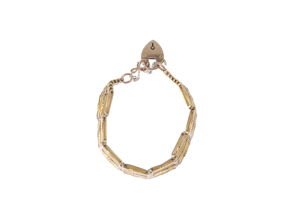 An early 20th century 9ct gold bracelet. Designed as a series of ten plain and twist-bar links, to - Image 2 of 2