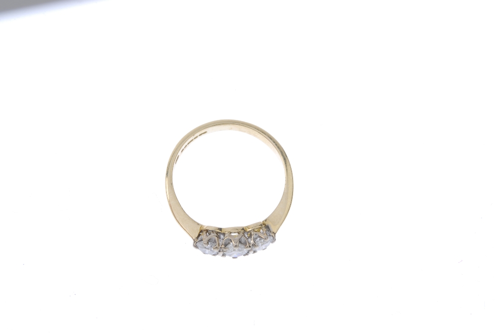 An 18ct gold diamond three-stone ring. The slightly graduated brilliant-cut diamond line, to the - Image 2 of 4