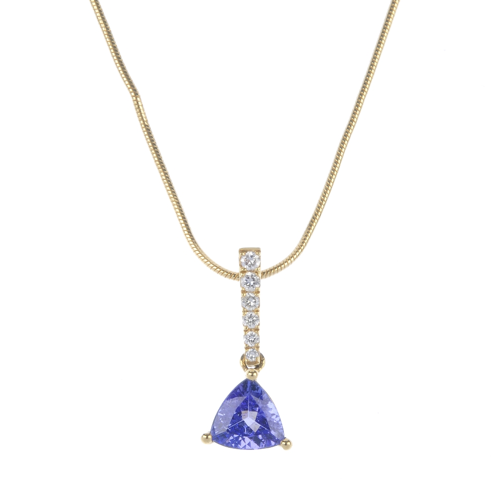 A tanzanite and diamond pendant. The triangular-shape tanzanite, to the graduated brilliant-cut