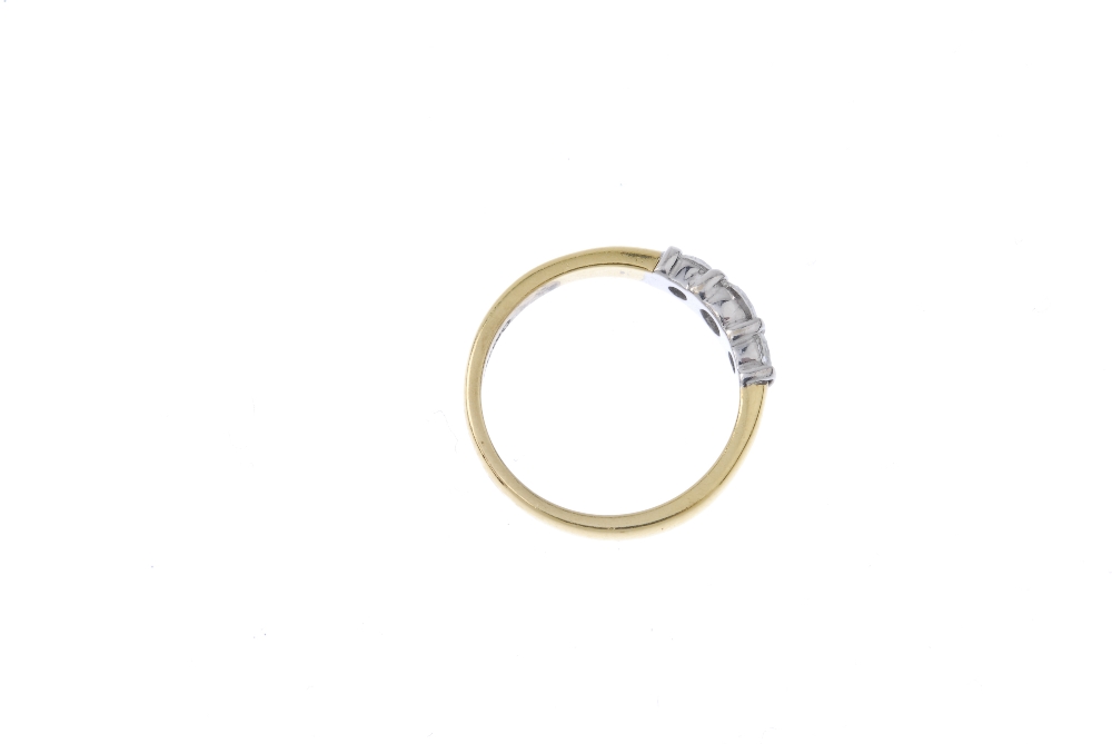 An 18ct gold diamond three-stone ring. The slightly graduated brilliant-cut diamond line, with bar - Image 4 of 4