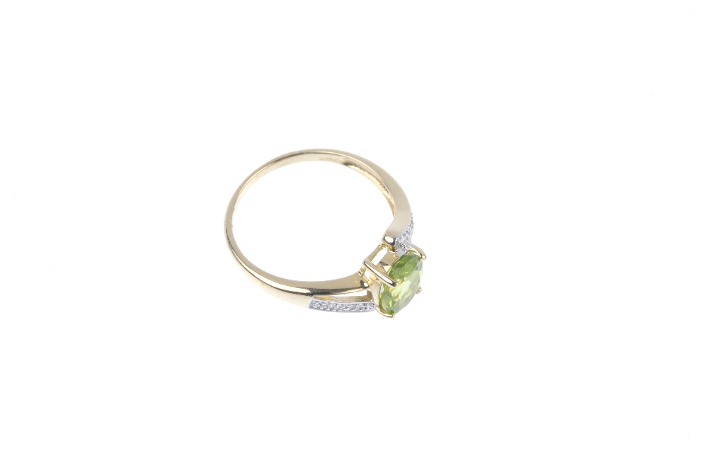 A 9ct gold peridot and diamond crossover ring. The oval-shape peridot, to the single-cut diamond - Image 3 of 4