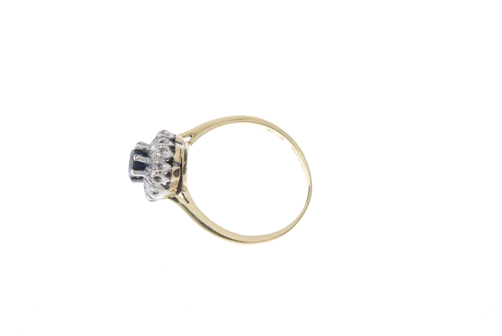 An 18ct gold sapphire and diamond cluster ring. The circular-shape sapphire, within a brilliant- - Image 3 of 4