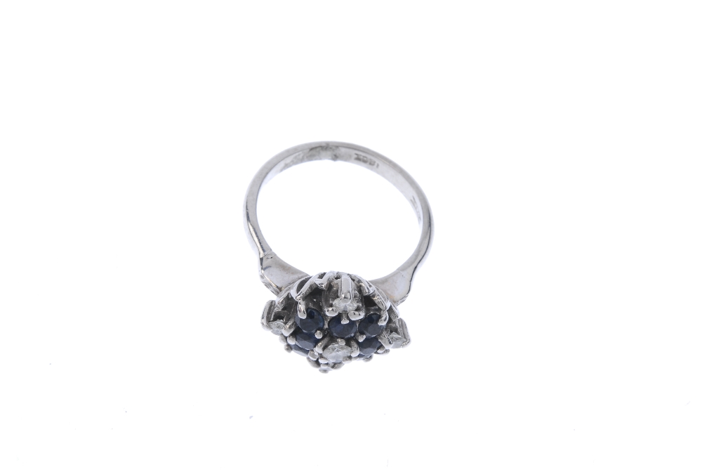 An 18ct gold sapphire and diamond cluster ring. The brilliant-cut diamond, within a circular-shape - Image 2 of 4