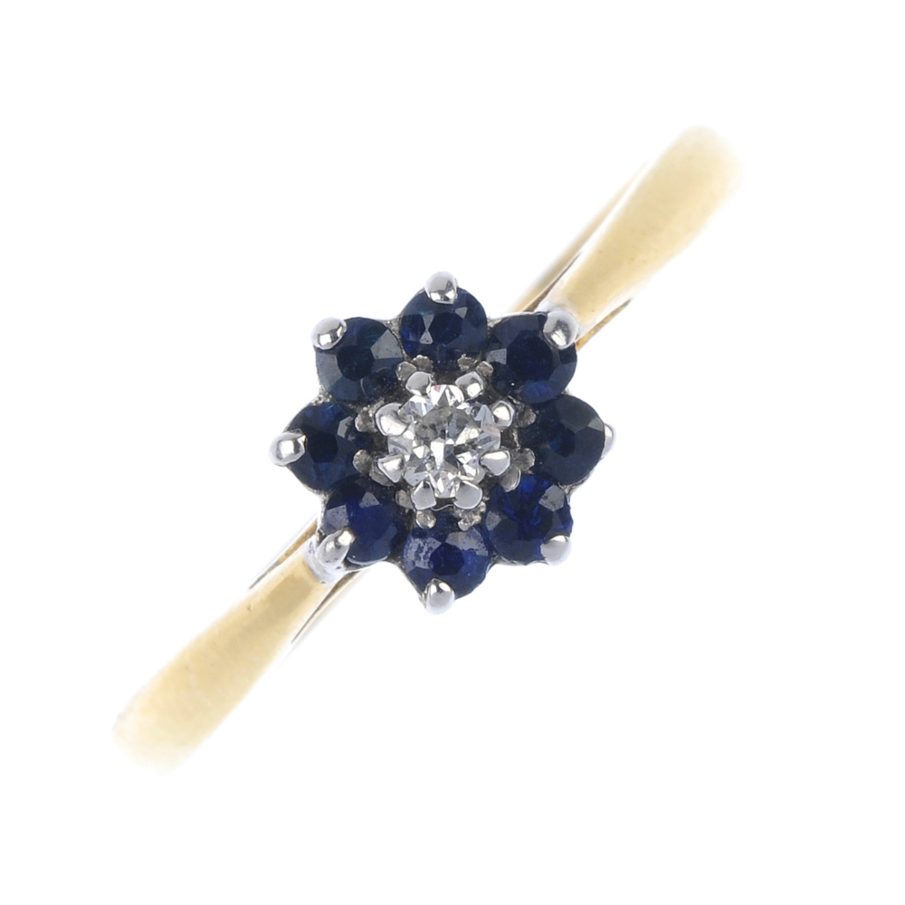 A diamond and sapphire cluster ring. The brilliant-cut diamond, within an circular-shape sapphire