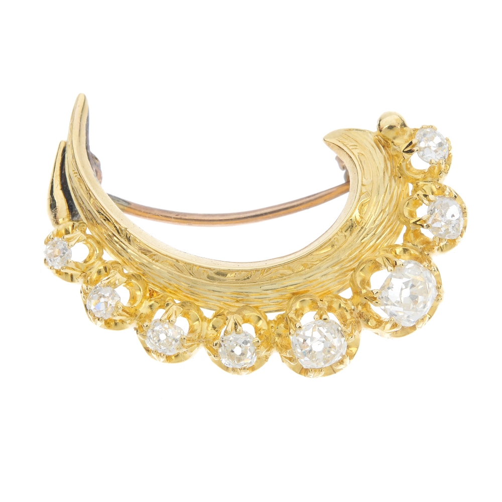 An old-cut diamond crescent brooch. The old-cut diamond curved line openwork gallery, to the