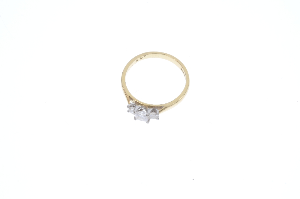 An 18ct gold diamond three-stone ring. The graduated square-shape diamond line, to the tapered - Image 2 of 4