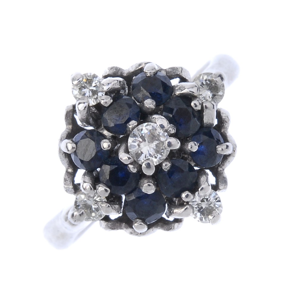 An 18ct gold sapphire and diamond cluster ring. The brilliant-cut diamond, within a circular-shape