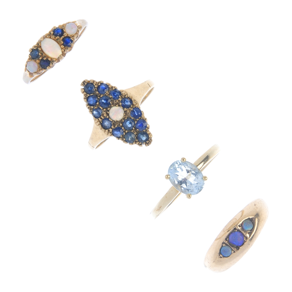 Four 9ct gold gem-set rings. To include an Edwardian opal three-stone band ring, an opal and