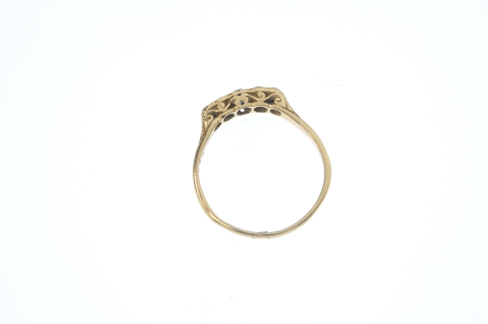 A 1920s 18ct gold diamond five-stone ring. The graduated old-cut diamonds, to the scrolling - Image 3 of 3