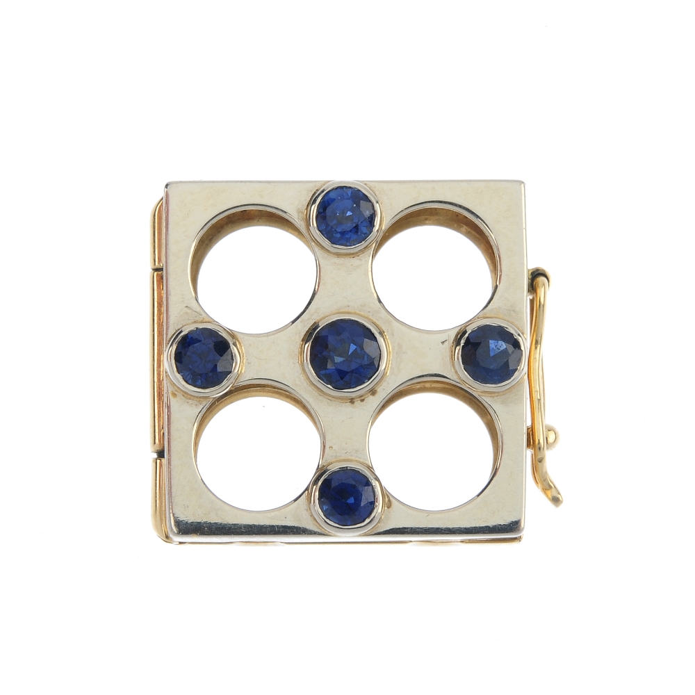 A sapphire pearl necklace enhancer. Of square-shape outline, set with circular-shape sapphires.