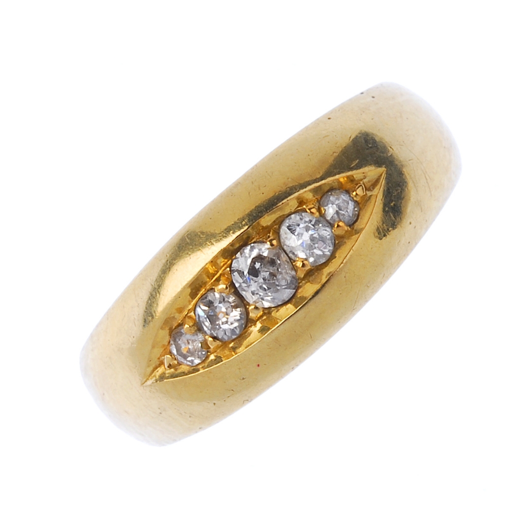 A mid-Victorian 22ct gold diamond five-stone ring. The graduated old-cut diamond line, inset to