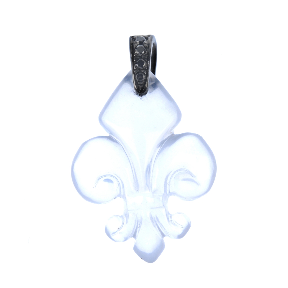 A chalcedony and gem-set pendant. The carved chalcedony fleur-de-lys, to the circular-shape black-