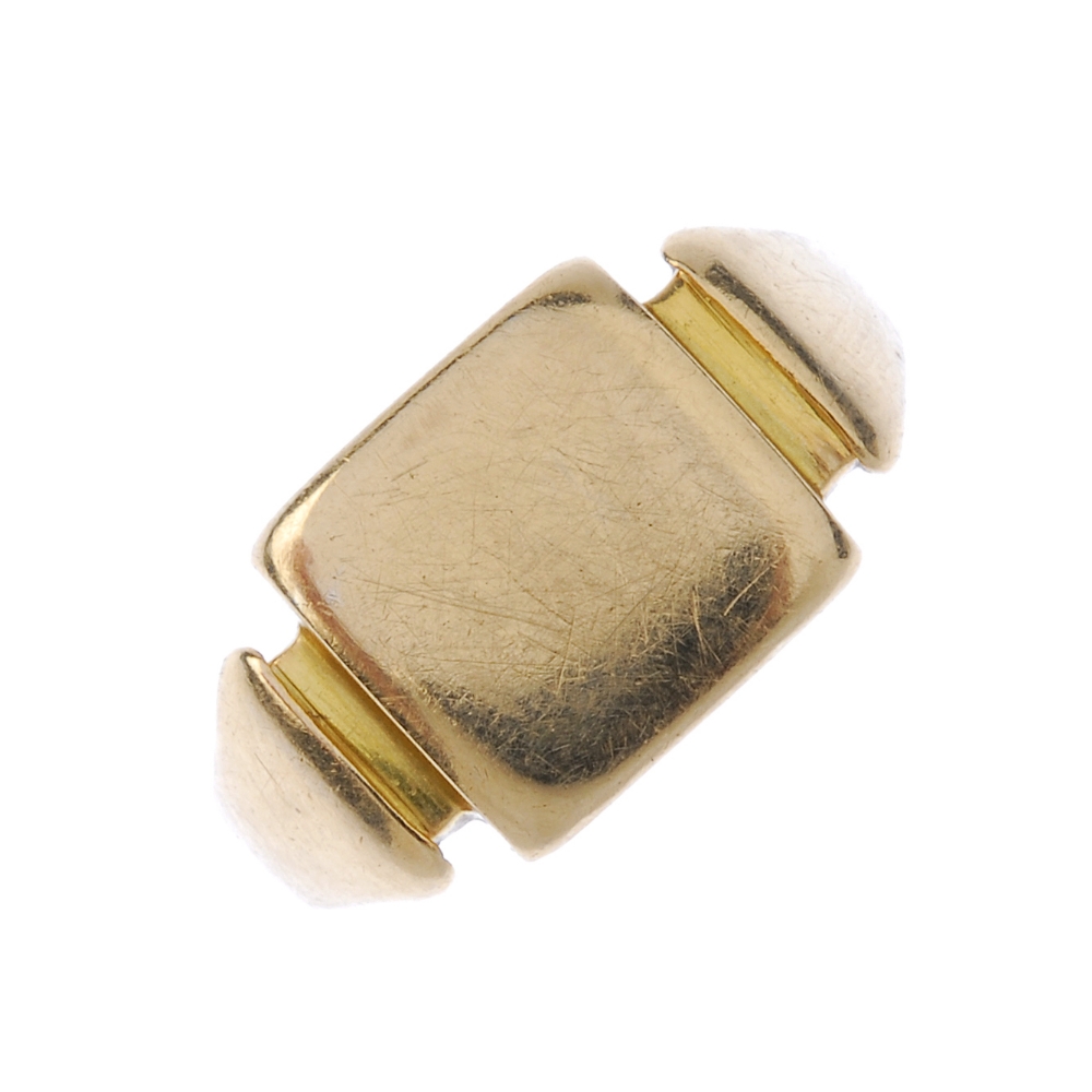 A signet ring. The square-shape panel, to the tapered shoulders and plain band. Weight 6.8gms.