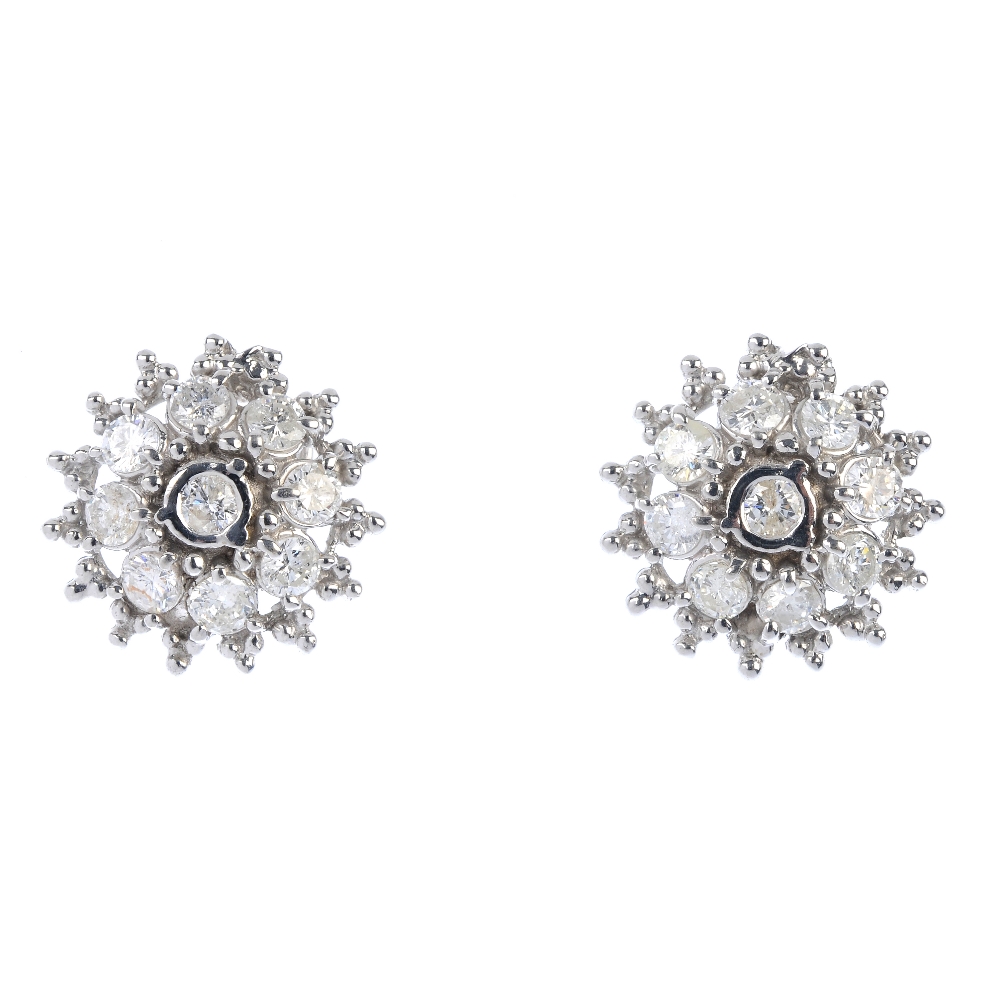 A pair of 14ct gold diamond cluster earrings. Each designed as a brilliant-cut diamond collet,