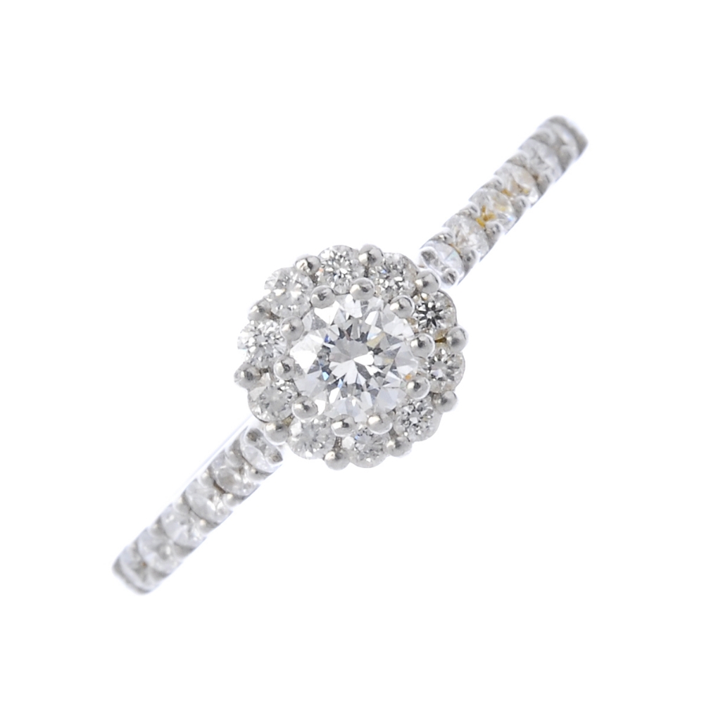 A platinum diamond cluster ring. The brilliant-cut diamond, with similarly-cut diamond surround