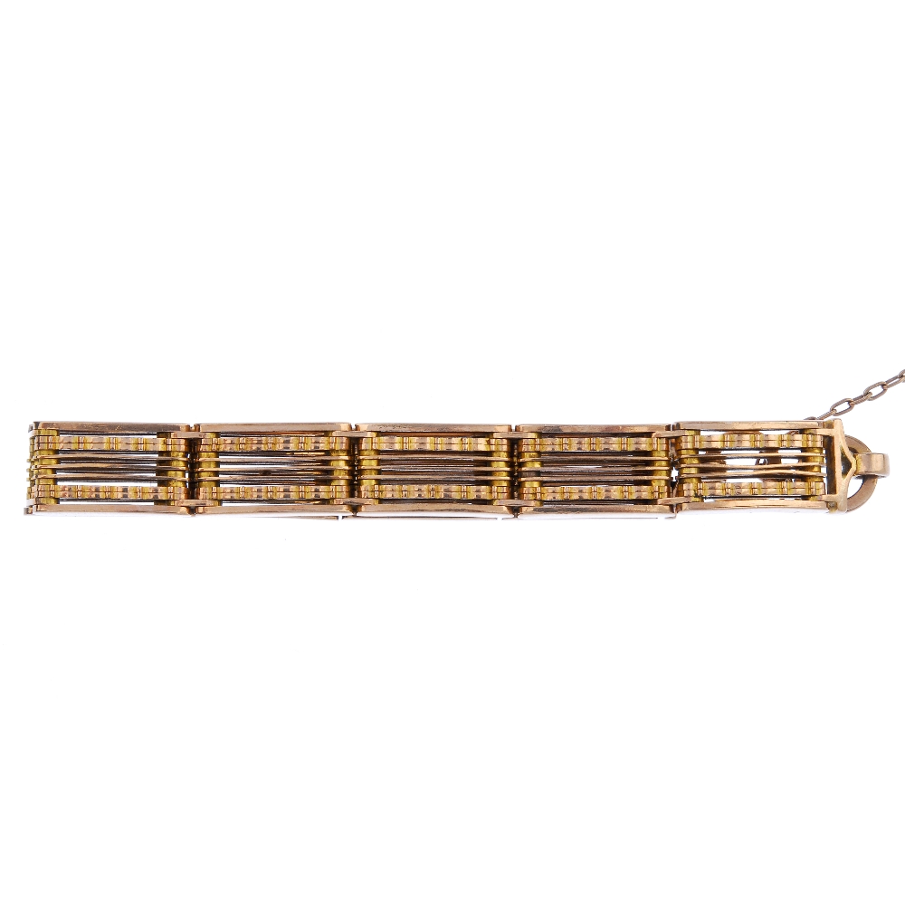 An early 20th century 9ct gold gate bracelet. Designed as a series of gate-links, with textured