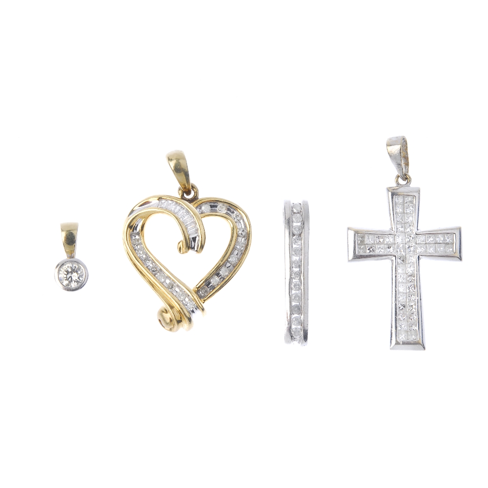 A selection of four diamond pendants. To include an 18ct gold diamond cross pendant, a 9ct gold