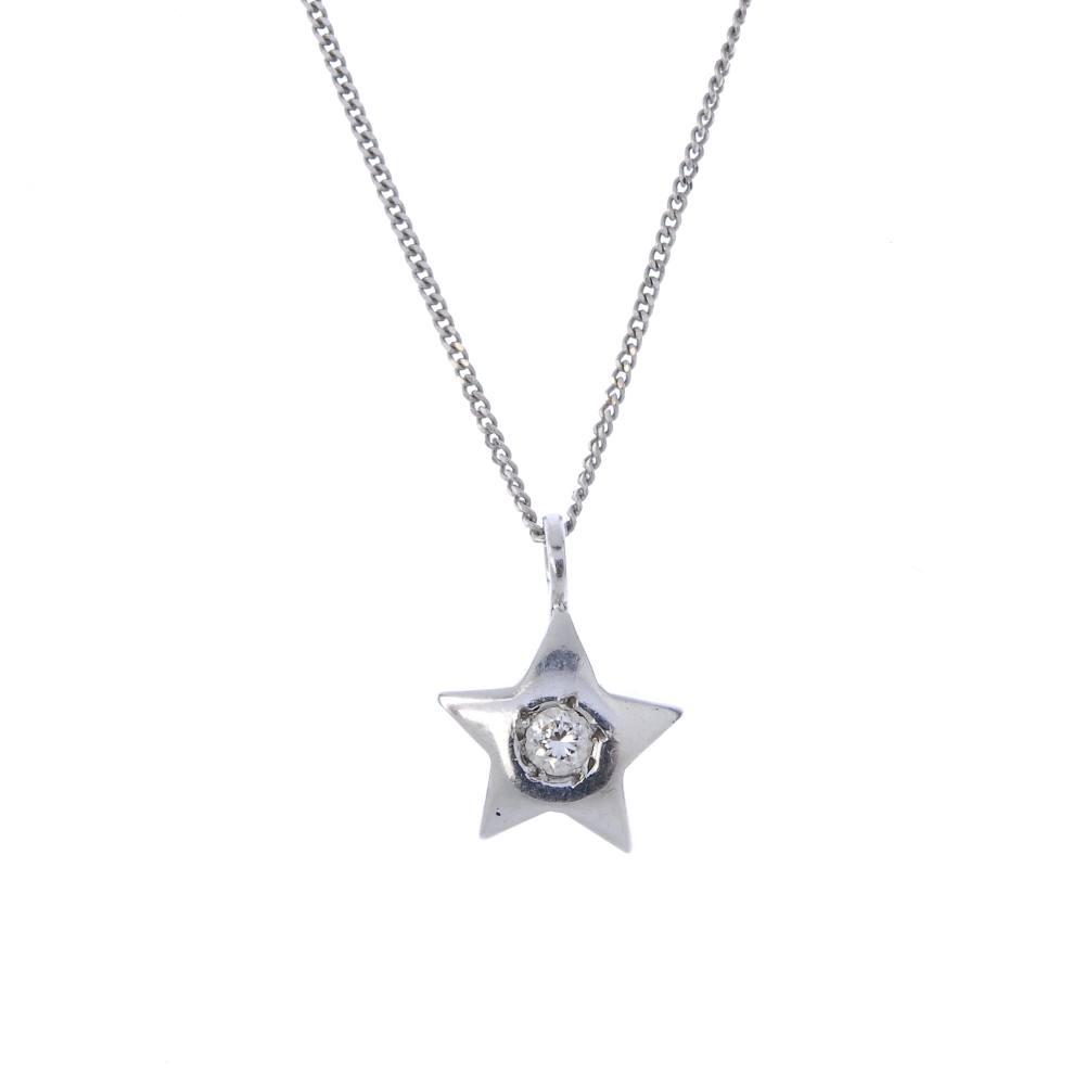 A diamond star pendant. The brilliant-cut diamond, within a star surround, suspended from an 18ct