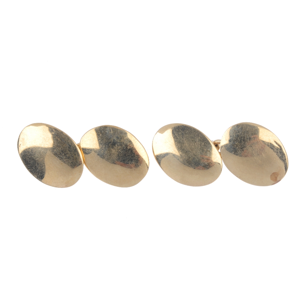 A pair of early 20th century 9ct gold cufflinks. Each designed as two oval-shape plain panels,