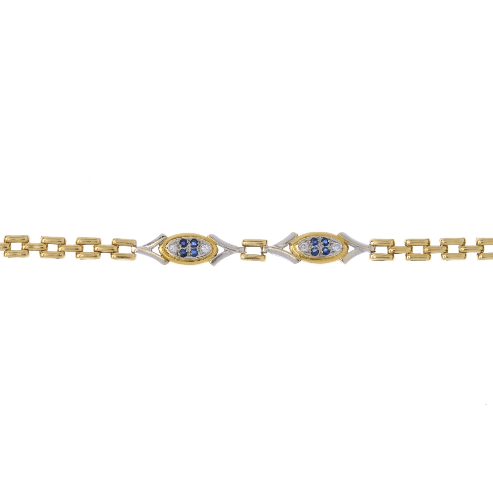 A sapphire and diamond bracelet. Of bi colour design, the circular-shape sapphire and brilliant-