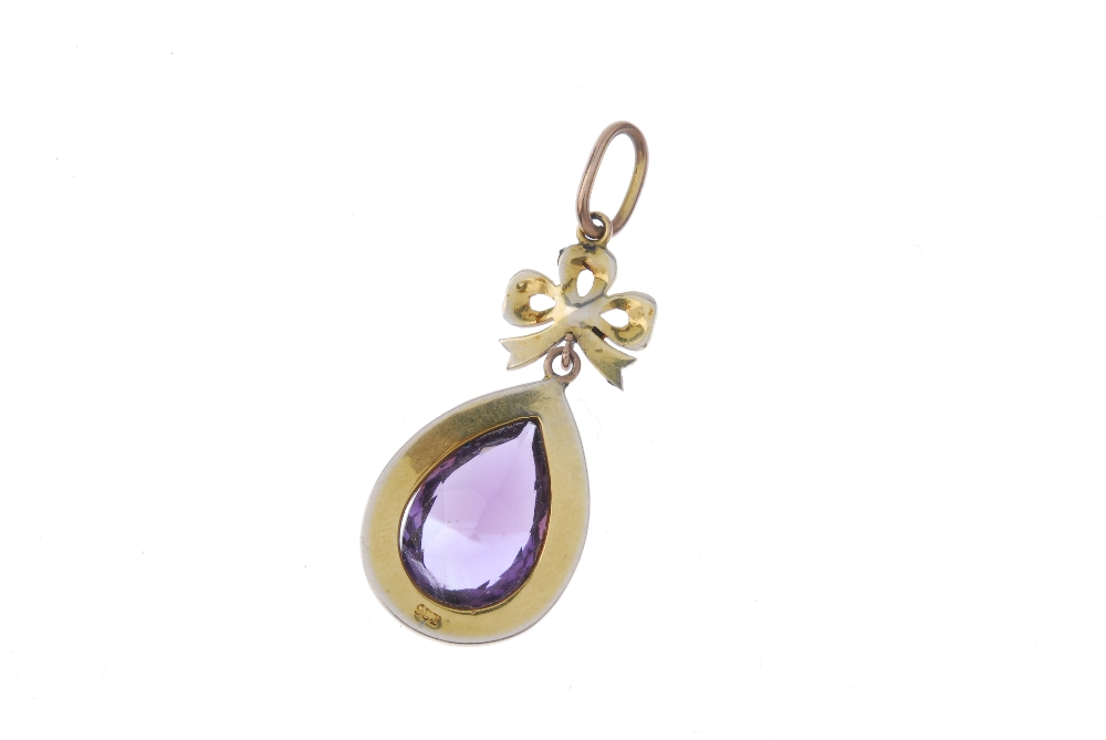 An early 20th century gold amethyst and split pearl pendant. The seed pearl bow, suspending a pear- - Image 2 of 2