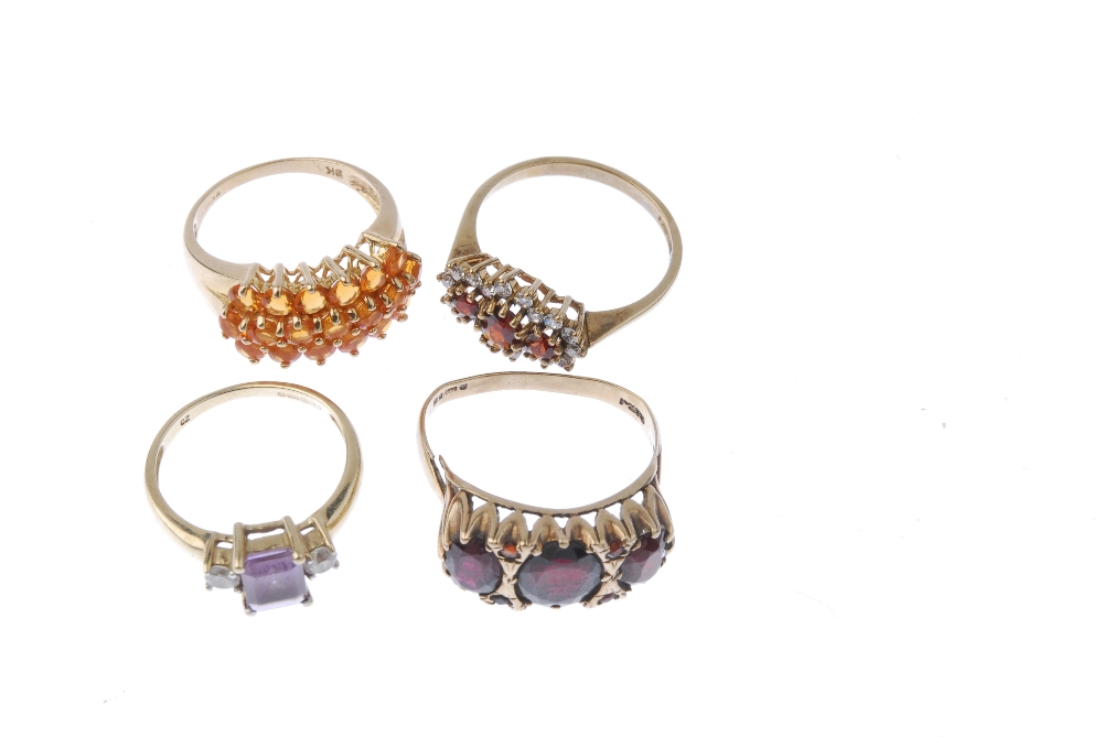 A selection of four 9ct gold gem-set rings. To include a fire opal dress ring, an amethyst and cubic - Image 2 of 4