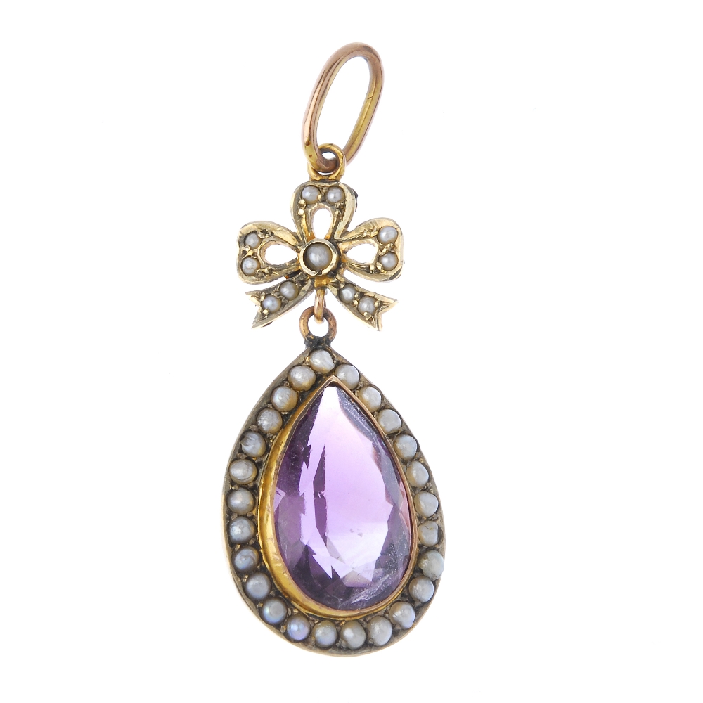 An early 20th century gold amethyst and split pearl pendant. The seed pearl bow, suspending a pear-