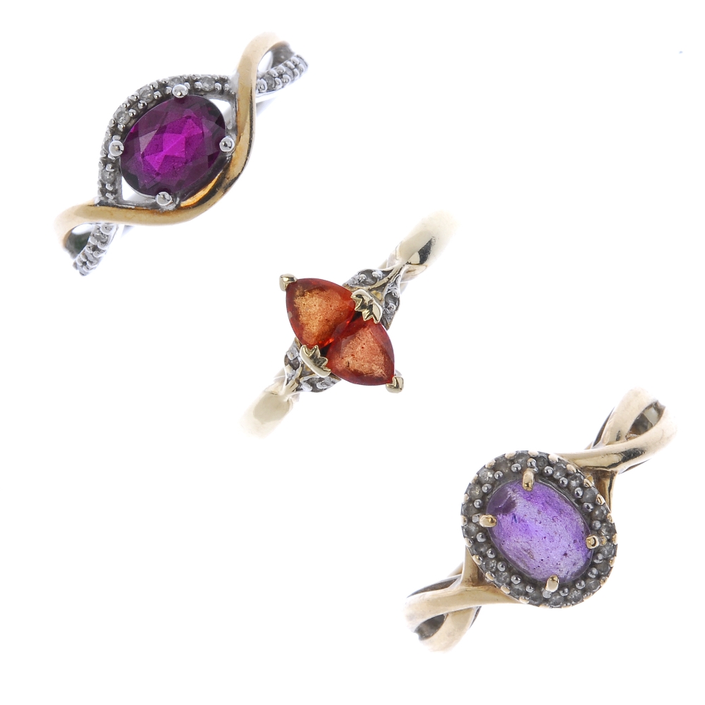 A selection of three diamond and gem-set rings. To include an amethyst and diamond cluster ring,