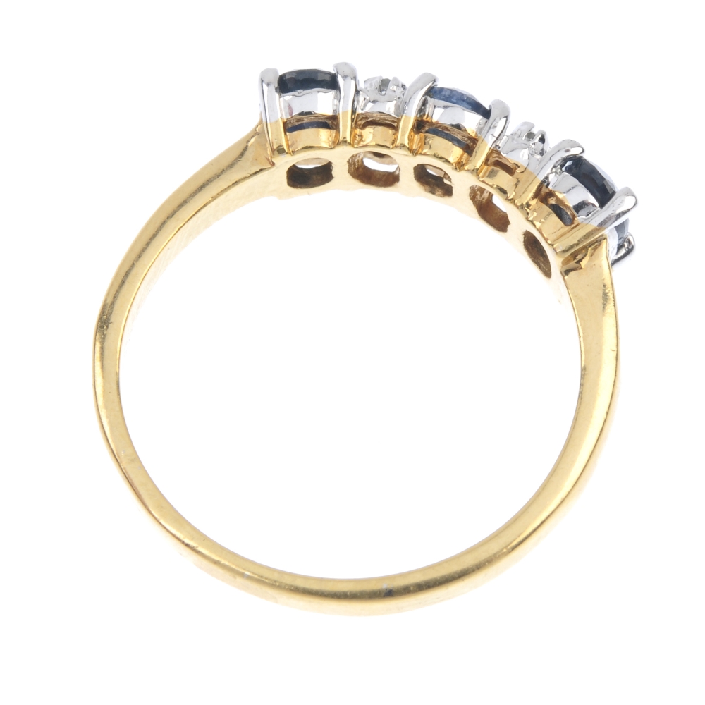 A sapphire three-stone and diamond accent ring. The oval-shape sapphire line, with diamond double - Image 4 of 4