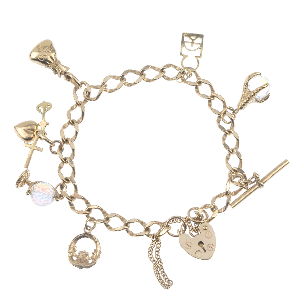 A 9ct gold bracelet, suspending seven charms. The curb-link bracelet, suspending charms, to