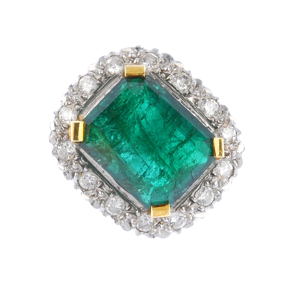 (539356-1-A) An 18ct gold emerald and diamond cluster ring. The rectangular-shape emerald, within