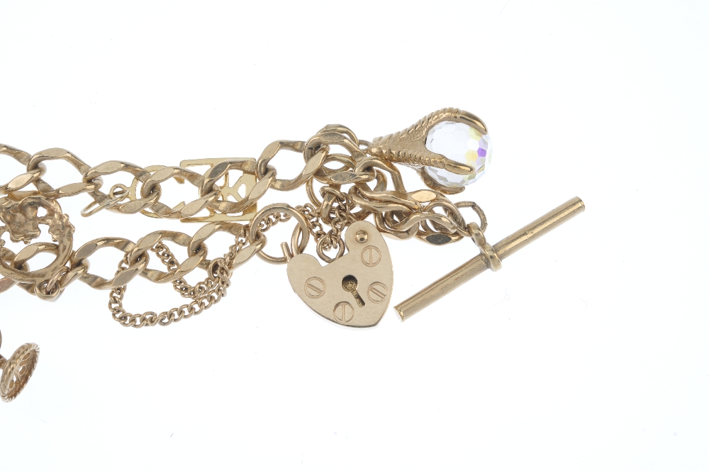 A 9ct gold bracelet, suspending seven charms. The curb-link bracelet, suspending charms, to - Image 3 of 3