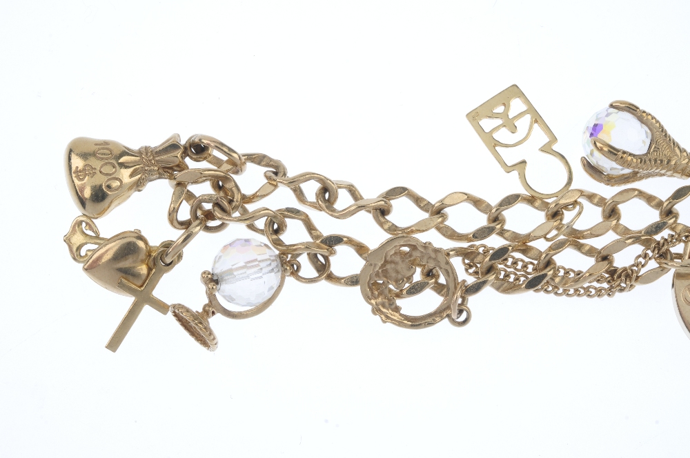 A 9ct gold bracelet, suspending seven charms. The curb-link bracelet, suspending charms, to - Image 2 of 3