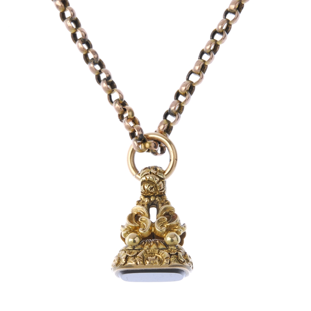 A late Victorian gold hardstone fob and later chain. The cushion-shape hardstone, to the scroll