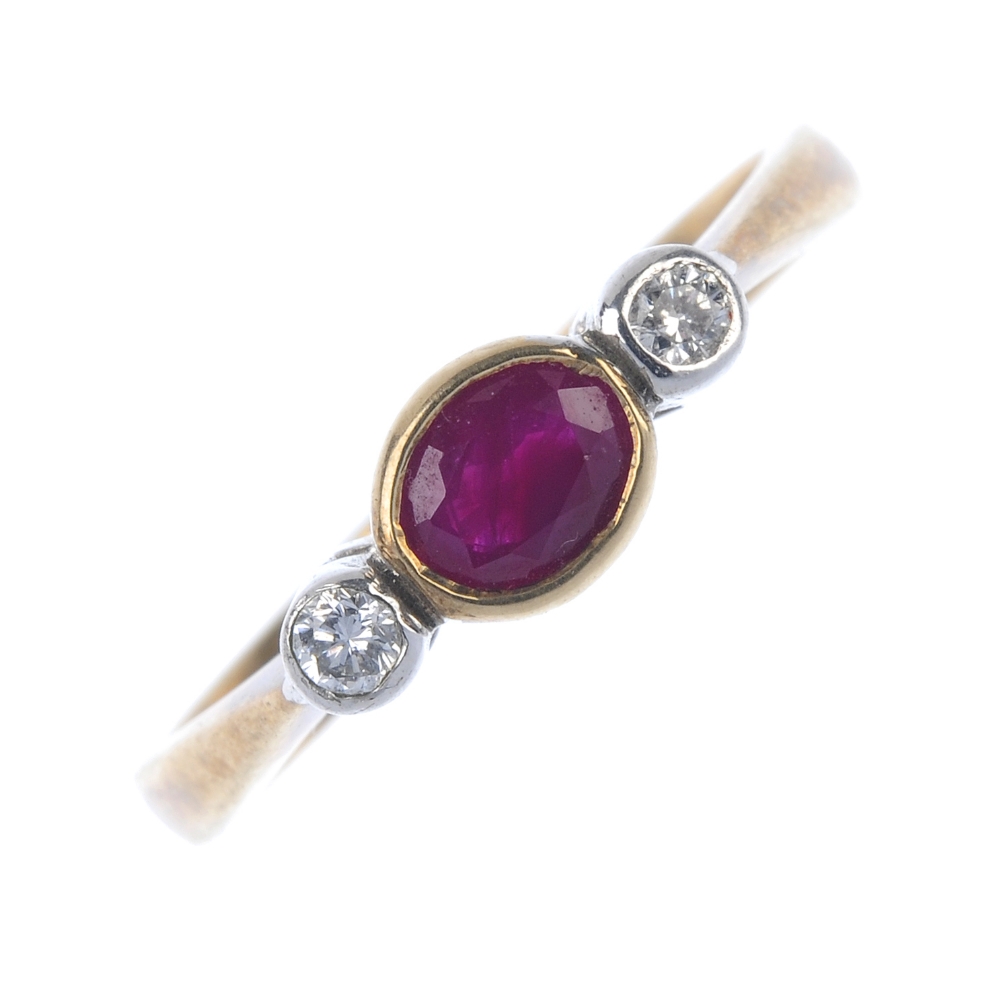 A 9ct gold ruby and diamond ring. The oval-shape ruby, with brilliant-cut diamond sides, to the