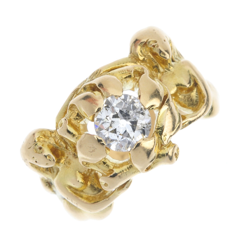 A 14ct gold diamond single-stone ring. The old-cut diamond, within an openwork setting, to the