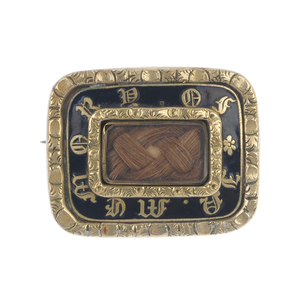A mourning brooch. Designed as a rectangular glazed panel with woven hair to the centre, to the