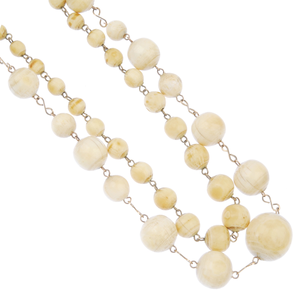 A selection of ivory and a bone napkin ring. To include three graduated ivory bead necklaces, a