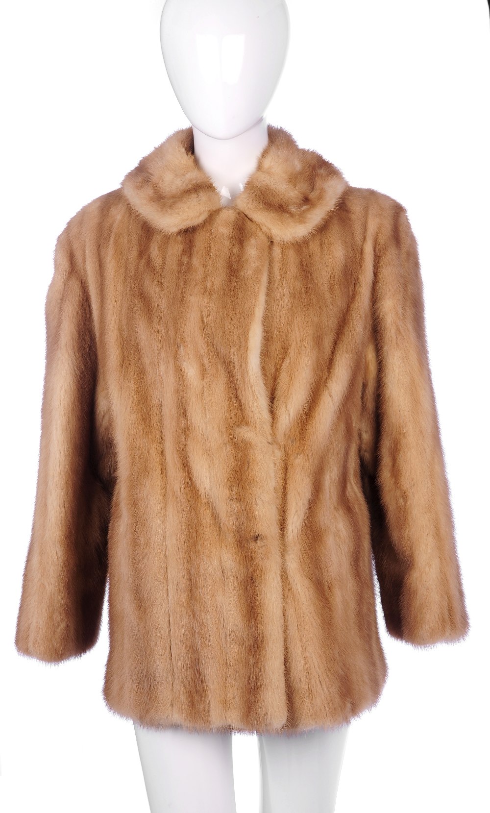 A three-quarter length pastel mink coat. Designed with a notched lapel collar, hook and eye