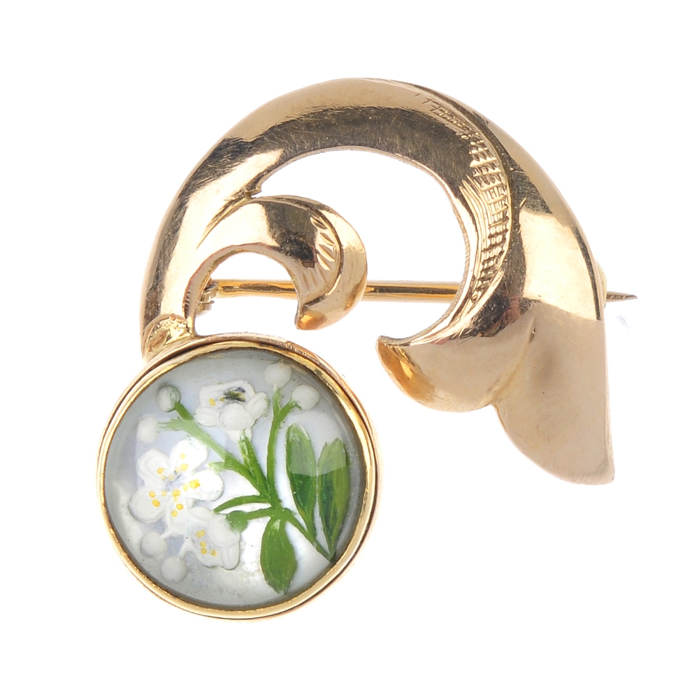 An early 20th century gold mother-of-pearl reverse carved intaglio brooch. Depicting white